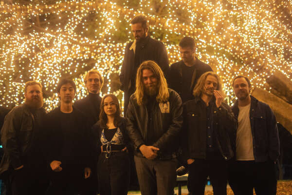 The Steele Syndicate full band shot in front of fairy lights